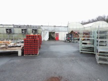 Outside: pallets of pots stored nearby, ready to be brought in when needed. In a few weeks, after it gets warmer, there will be plants on display.